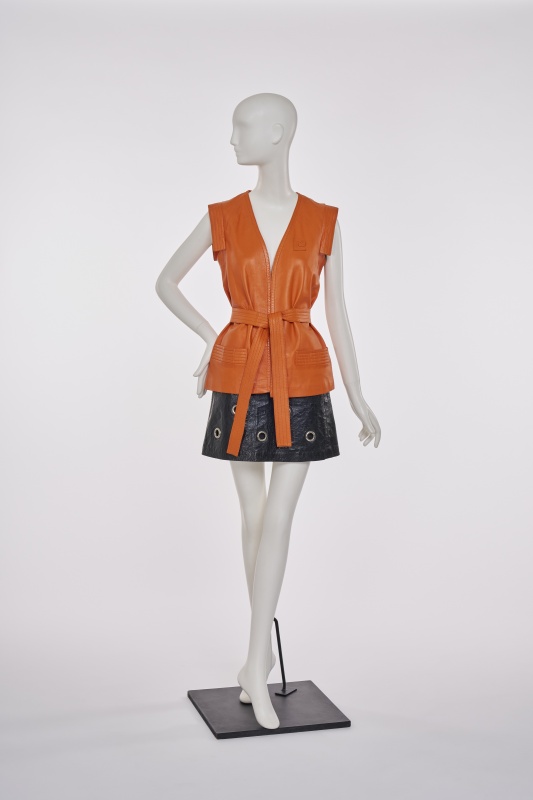 A Pierre Cardin orange leather gilet and black imitation leather miniskirt, late 1960s